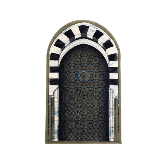 Islamic prayer rug featuring an arched mihrab design with geometric pattern and striped arch detailing