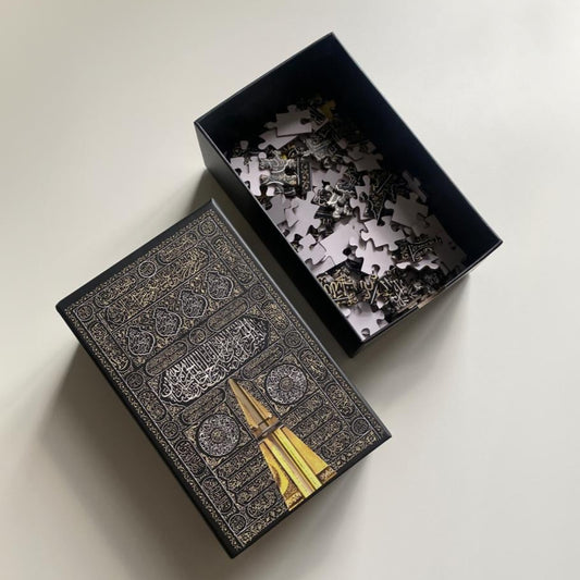 Islamic jigsaw puzzle inspired by the door of the Kaaba shown with puzzle box and loose pieces