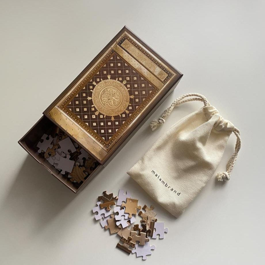 Islamic jigsaw puzzle inspired by the door of the Prophet’s Mosque shown with puzzle box and drawstring pouch
