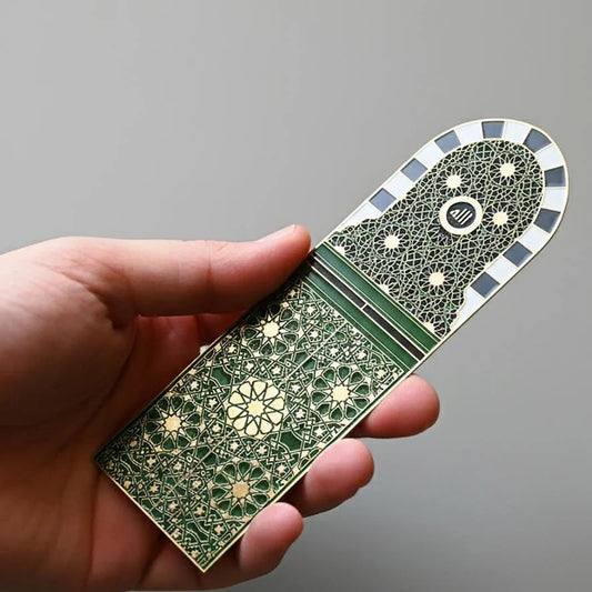 Gold metal bookmark engraved with Islamic geometric patterns inspired by the door of the Grand Mosque Makkah